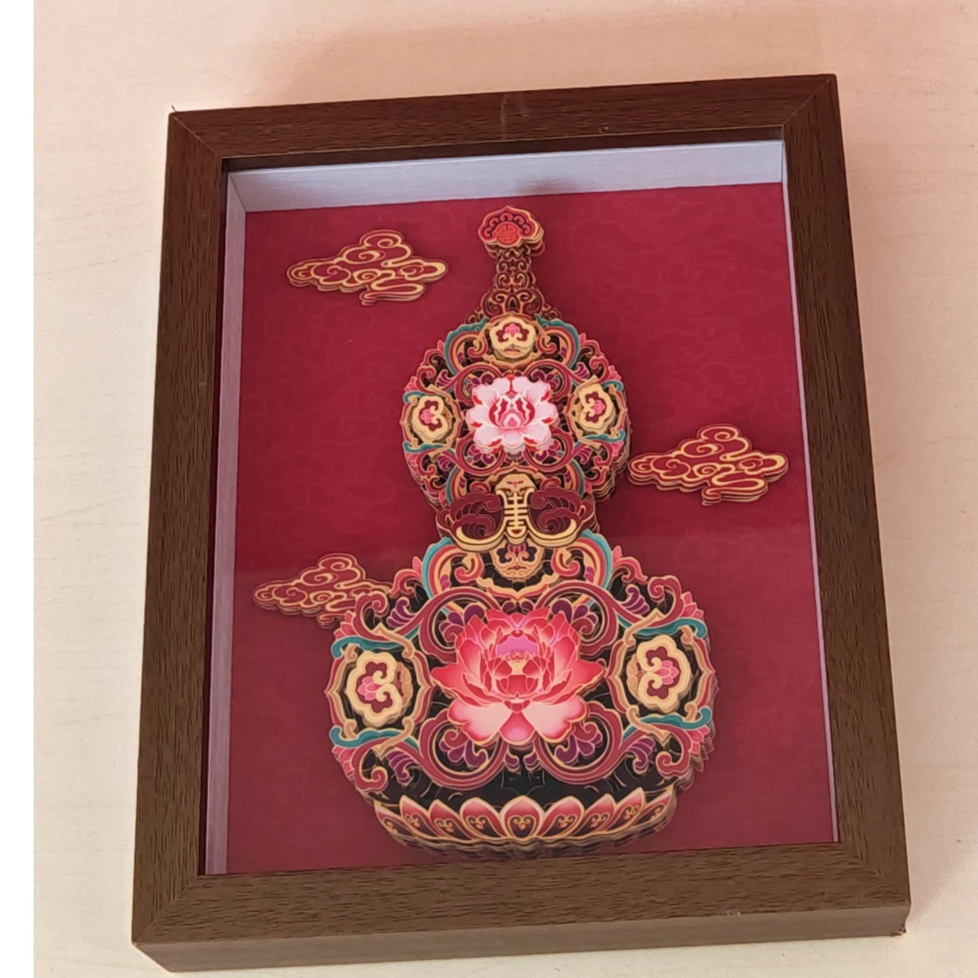 A framed layered-paper gourd artwork